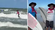 Surfistas gaúchos encaram ondas com chapéu e lenço no pescoço em festival no RS