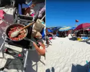 Turistas usam fogareiro para cozinhar linguiça na areia da Praia do Forte em Cabo Frio