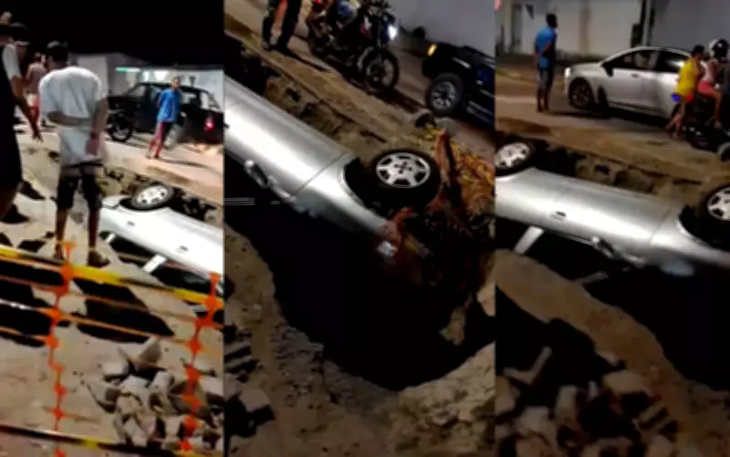 Carro cai em buraco de obra e fica inclinado em rua de Feira de Santana, Bahia