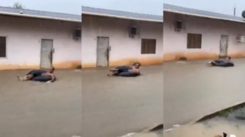Morador usa boia para 'surfar' em rua alagada durante temporal no Amapá
