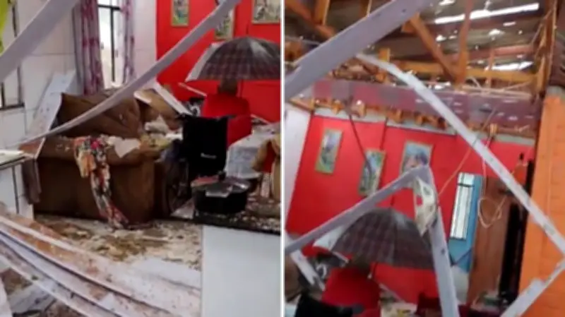 Idoso cadeirante se protege de granizo com guarda-chuva após temporal destruir telhado no PR